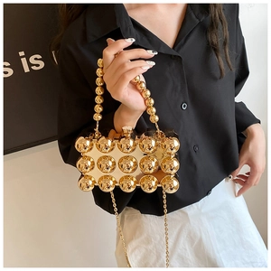 Detail of gold beaded evening clutch with metallic sphere design and chain strap