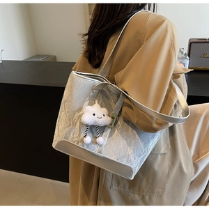 Silver metallic tote bag with pleated texture and white cloud charm shown on shoulder