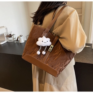 Brown large capacity tote bag with pleated texture and white cloud plush charm detail