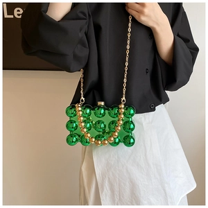Macro detail of green acrylic bag featuring 3D bead texture and gold bead handle