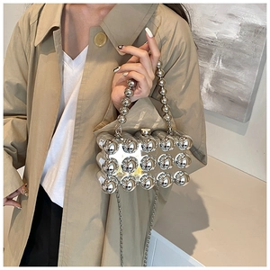 Detailed view of silver acrylic evening bag with 3D bubble texture and ball handle