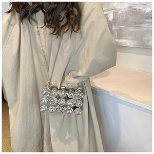 Silver beaded crossbody bag with metallic mirror spheres and slim chain strap detail