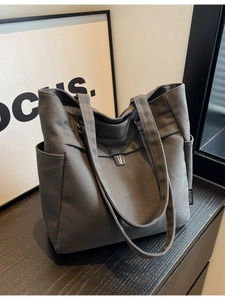 Deep grey canvas tote bag for work and study featuring a large capacity and side pocket