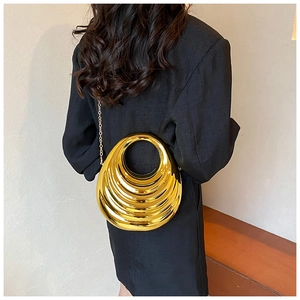 Close-up of golden irregular shell evening bag with concentric tiered design and chain