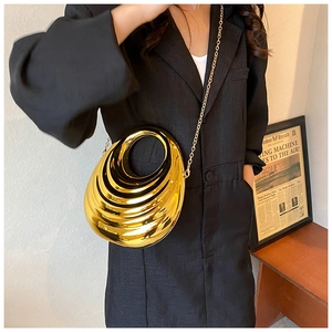 Sleek gold acrylic hard shell evening clutch bag with circular handle and chain strap