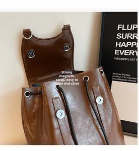 Detail of brown PU backpack featuring strong magnetic buckles and easy drawstring closure