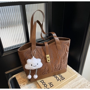 Brown tote bag with pleated texture featuring a cute white plush cloud charm on side