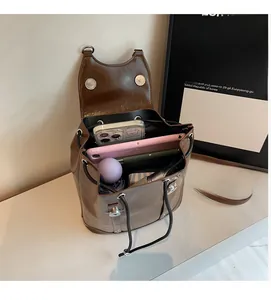 Interior view showing the large storage capacity of the brown faux leather backpack