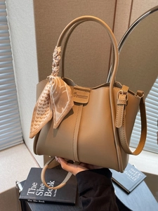 Khaki leather bucket tote bag with decorative geometric scarf and crossbody strap