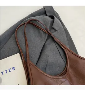 Detail of dark brown woven leather handles on an elegant tote bag for daily commute