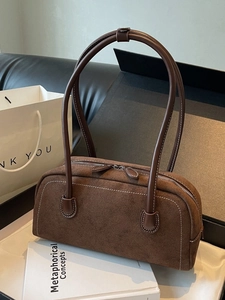 Retro brown suede barrel bag with contrast stitching and shoulder strap for women