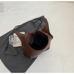 Detailed top view of a large brown tote bag showing magnetic closure and inner zipper pocket