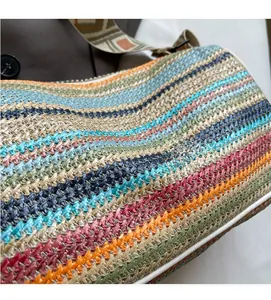 Close-up of colorful striped straw bag featuring detailed texture and patterned shoulder strap