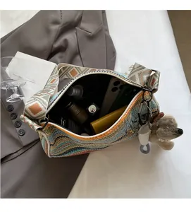 Interior view of colorful woven bag showing large capacity with phone and wallet inside