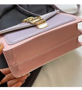 Detail of pink and purple crossbody bag showing multilayered structure and gold buckle