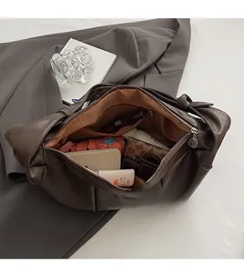 Spacious interior of retro brown hobo bag showing large storage capacity and inner pocket