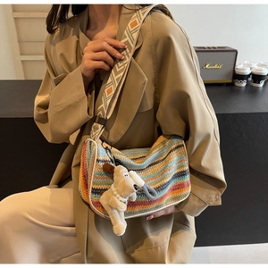 Rainbow woven crossbody bag with jacquard strap and plush puppy charm detail