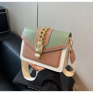 Detail of color-block flap bag with gold chain and wide woven shoulder strap