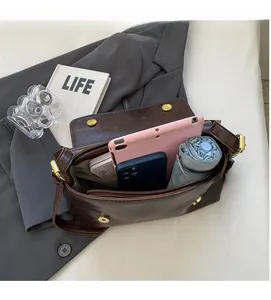 Interior view showing the large capacity and pockets of the vintage brown messenger bag