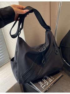 Versatile black nylon crossbody tote bag with multiple zipper pockets and adjustable strap