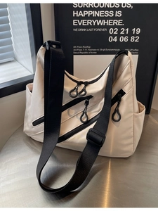 Chic beige nylon crossbody tote with multi-zipper pockets and wide strap