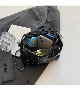 Spacious interior of a black quilted handbag with studs and stylish acrylic chain handles