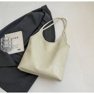 Detailed top view of a large cream tote bag showing its unique textured leather surface