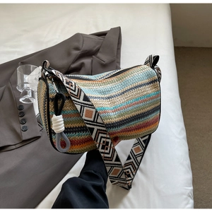 Detail of colorful woven shoulder bag with bohemian patterns and textured stripe fabric