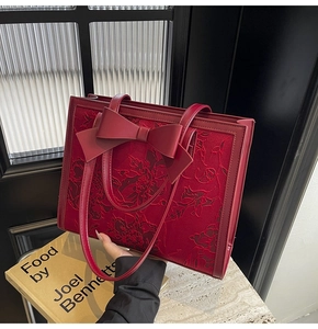 Detailed view of dark red jacquard bridal tote bag with flower lace and large bow
