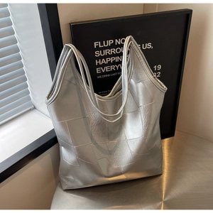 Detail of silver metallic tote bag with block splicing and woven texture effect