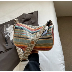 Close-up of bohemian rainbow woven bag featuring colorful wave textures and a geometric strap