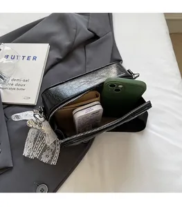 Detail showing internal storage capacity for phone and wallet in black soft leather bag