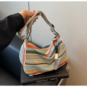 Detail of bohemian rainbow woven crossbody bag with jacquard strap and white trim