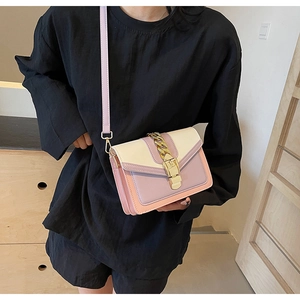 Fashionable color-block crossbody bag featuring a golden chain and lavender strap detail