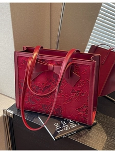 Elegant deep red bridal handbag with jacquard floral lace and bow detail for weddings