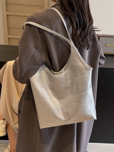 Silver geometric tote bag with metallic texture shown as a stylish shoulder bag