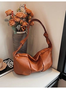 Minimalist caramel brown pleated cloud shoulder bag with knotted strap design
