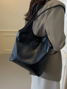 Fashionable black leather tote bag with geometric patchwork and double shoulder straps