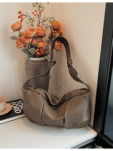 Minimalist soft leather pleated shoulder bag in vintage brown with a knotted strap design