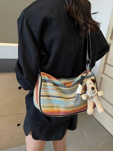 Rainbow striped woven crossbody bag with Gromit plush charm and black wide shoulder strap