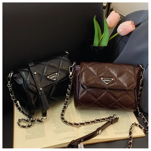 Quilted crossbody bags in black and brown leather on books with tulip decor