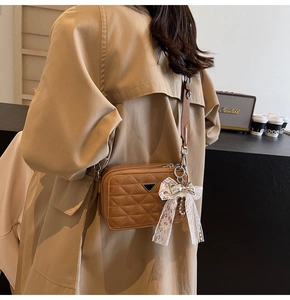 Quilted soft leather camera bag with pearl lace bow and adjustable woven strap