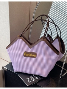 Fashionable purple pleated tote bag with contrasting brown straps and gold-tone logo