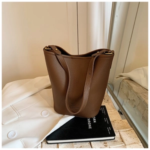 Chic brown lychee pattern leather bucket bag with adjustable gold hardware and shoulder strap