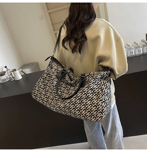 Close-up of lightweight travel tote with geometric pattern and adjustable shoulder strap