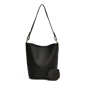 Minimalist black lychee leather bucket bag with gold hardware and PARIS engraving