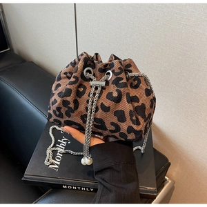 Close-up of leopard print bucket bag with silver metal chain and pearl charm detail
