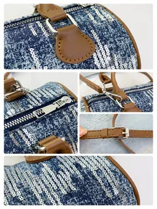 Close-up of blue denim Boston bag with silver sequins and brown leather straps