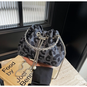 Detail of leopard print bucket bag with metal chain handle and pearl drawstring charms