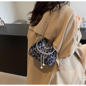 Detail of leopard print bucket bag with silver chain strap and pearl drawstring charms
